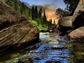 Scenic view of river against cloudy sky