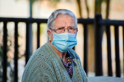 Close-up portrait of an older woman wearing a mask person