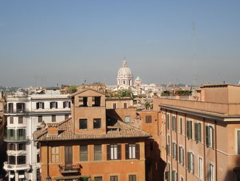 Buildings in city against clear sky