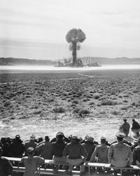 Rear view of people looking at sea against sky