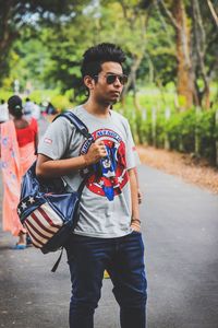 Full length of young man walking on road