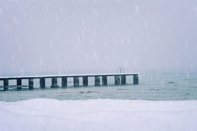 Pier over sea against sky