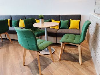 Multi colored chairs on table at home