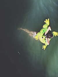 High angle view of woman swimming in sea