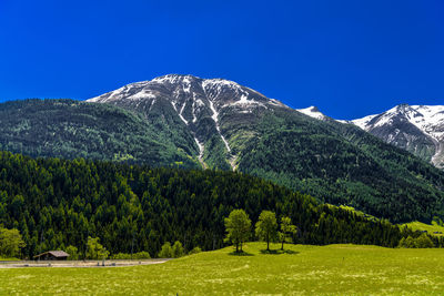 Scenic view of mountains against clear blue sky