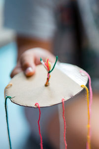 Close-up of woman making colorful decoration