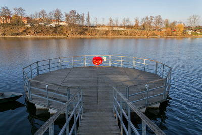 Pier over lake against sky