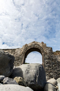 Low angle view of old ruins against sky