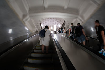 People on escalator at subway station
