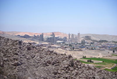 View of built structures against clear blue sky