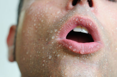 Close-up of sweaty man with mouth open