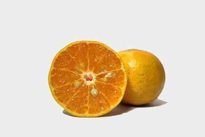 Close-up of orange slice against white background