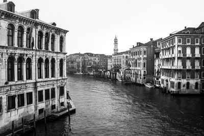 Boats in canal with buildings in background