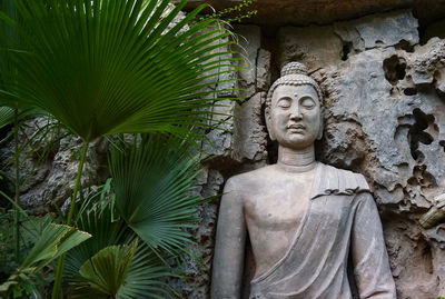 Buddha statue against trees