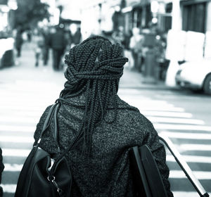 Rear view of woman walking on street in city