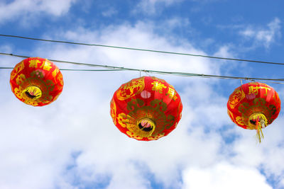 Low angle view of lanterns hanging against the sky