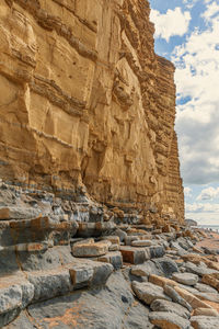 Low angle view of rock formation against sky