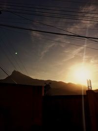 Scenic view of silhouette mountains against sky at sunset