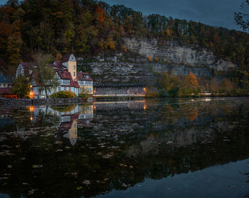 Reflection of trees and building on lake