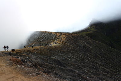 People on mountain during foggy weather