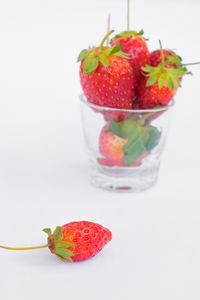 Close-up of strawberries on glass against white background