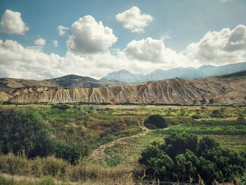 Scenic view of landscape against cloudy sky