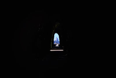 Silhouette of building in tunnel