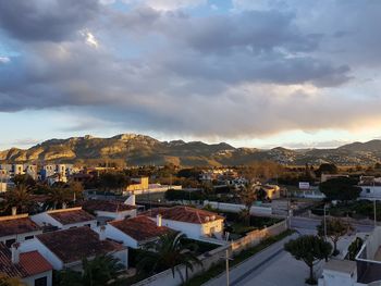 High angle view of houses in town against sky