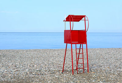 Lifeguard hut on beach against clear sky