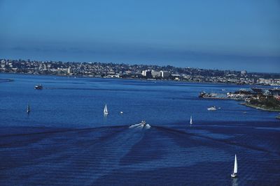 High angle view of sea and cityscape against sky