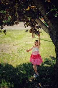 Full length of girl standing on field