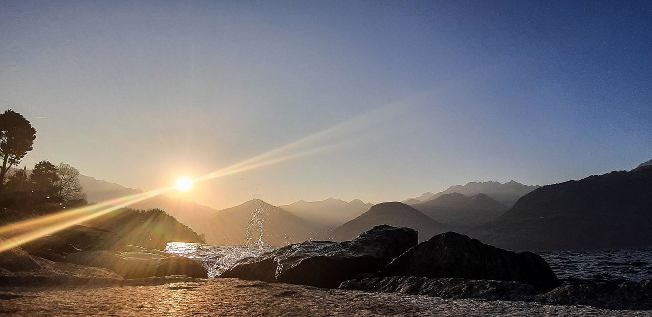 SCENIC VIEW OF MOUNTAINS AGAINST SKY DURING BRIGHT SUN