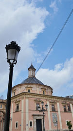 Low angle view of building against cloudy sky