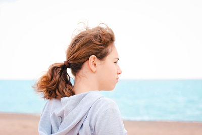 Portrait of mature woman on beach against sky