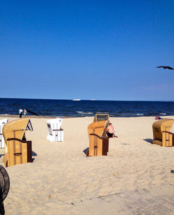 Scenic view of beach against clear blue sky