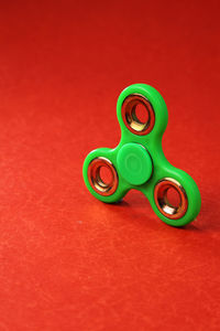 Close-up of fidget spinner on red table