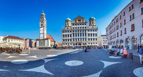 Group of people in front of buildings in city