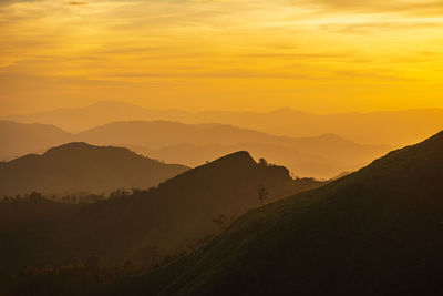 Scenic view of silhouette mountains against sky during sunset