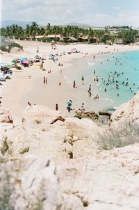 Crowd at beach on sunny day