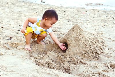 Full length of girl playing at beach