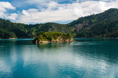 Scenic view of marlborough sounds sea coast by mountains against sky