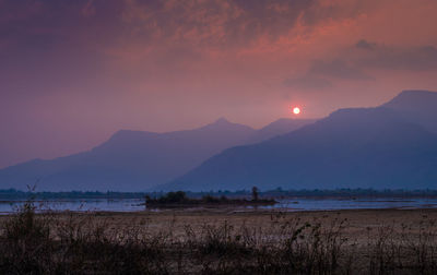 Scenic view of lake against sky during sunset