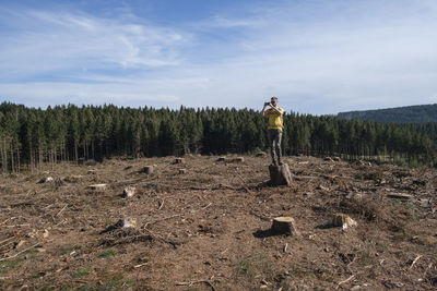 Full length of man standing on land against sky