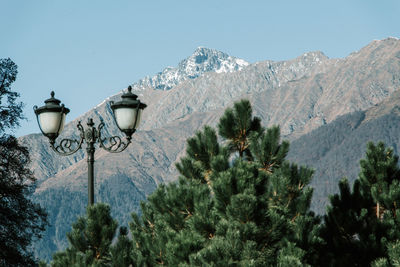 Street light and mountains against clear sky
