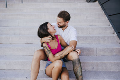 Young couple sitting on staircase