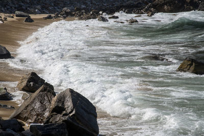 Waves splashing on rocks at shore