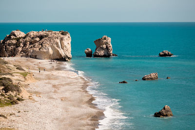 Scenic view of rocks in sea against clear sky