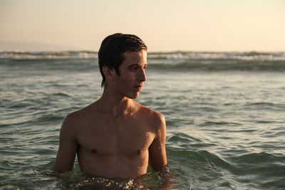 Man looking at sea shore against sky