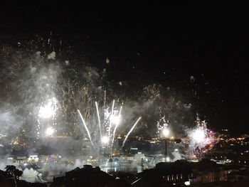 Low angle view of firework display at night