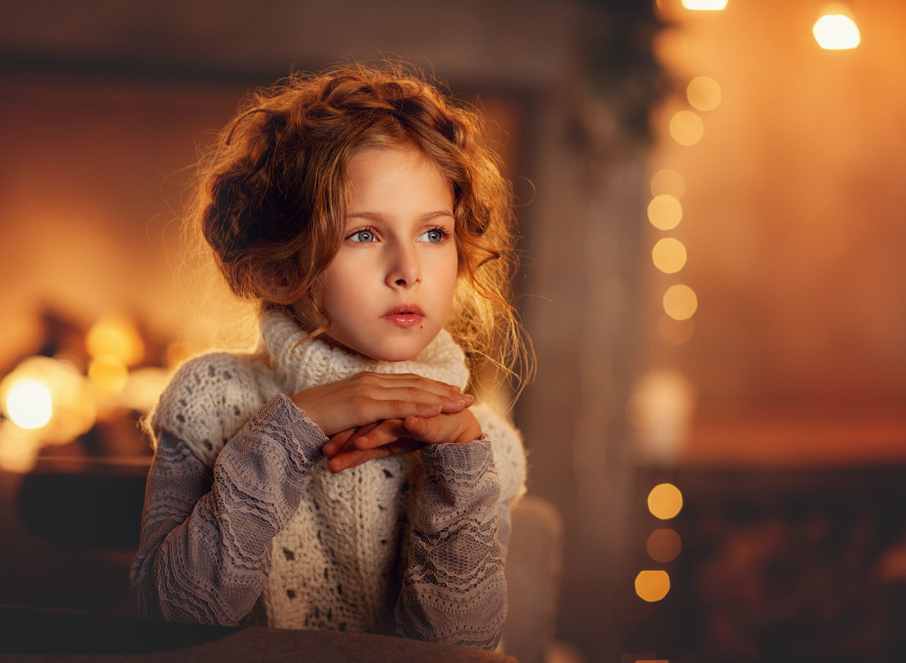 PORTRAIT OF GIRL LOOKING AWAY AT ILLUMINATED NIGHTCLUB